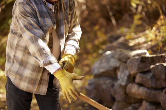 Picture of someone putting on gloves to do work outside